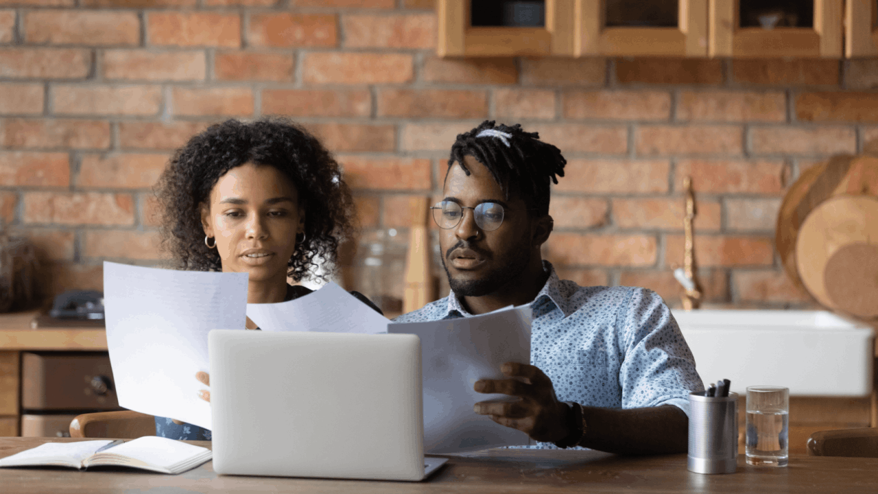 Is 30000 debt a lot — couple reviewing financial documents together at home