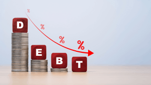 Red wooden blocks spelling DEBT on descending coin stacks showing what debts cannot be discharged in bankruptcy versus dischargeable obligations
