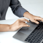 how to handle large debt - professional woman working on laptop with financial charts