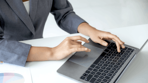 how to handle large debt - professional woman working on laptop with financial charts