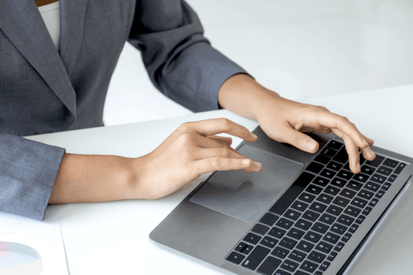 how to handle large debt - professional woman working on laptop with financial charts