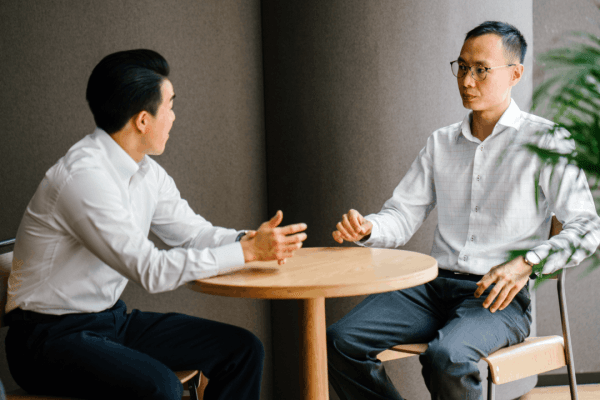 how to manage overwhelming debt - two professionals having a serious financial consultation
