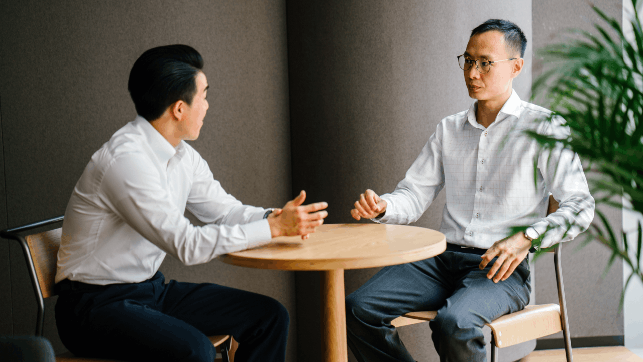 how to manage overwhelming debt - two professionals having a serious financial consultation