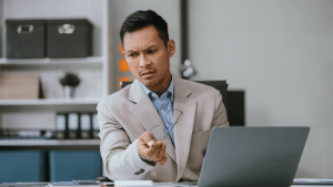 Should I file bankruptcy for debt — concerned businessman researching options on laptop