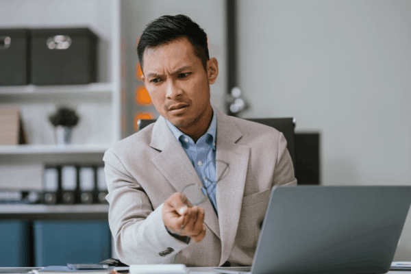 Should I file bankruptcy for debt — concerned businessman researching options on laptop
